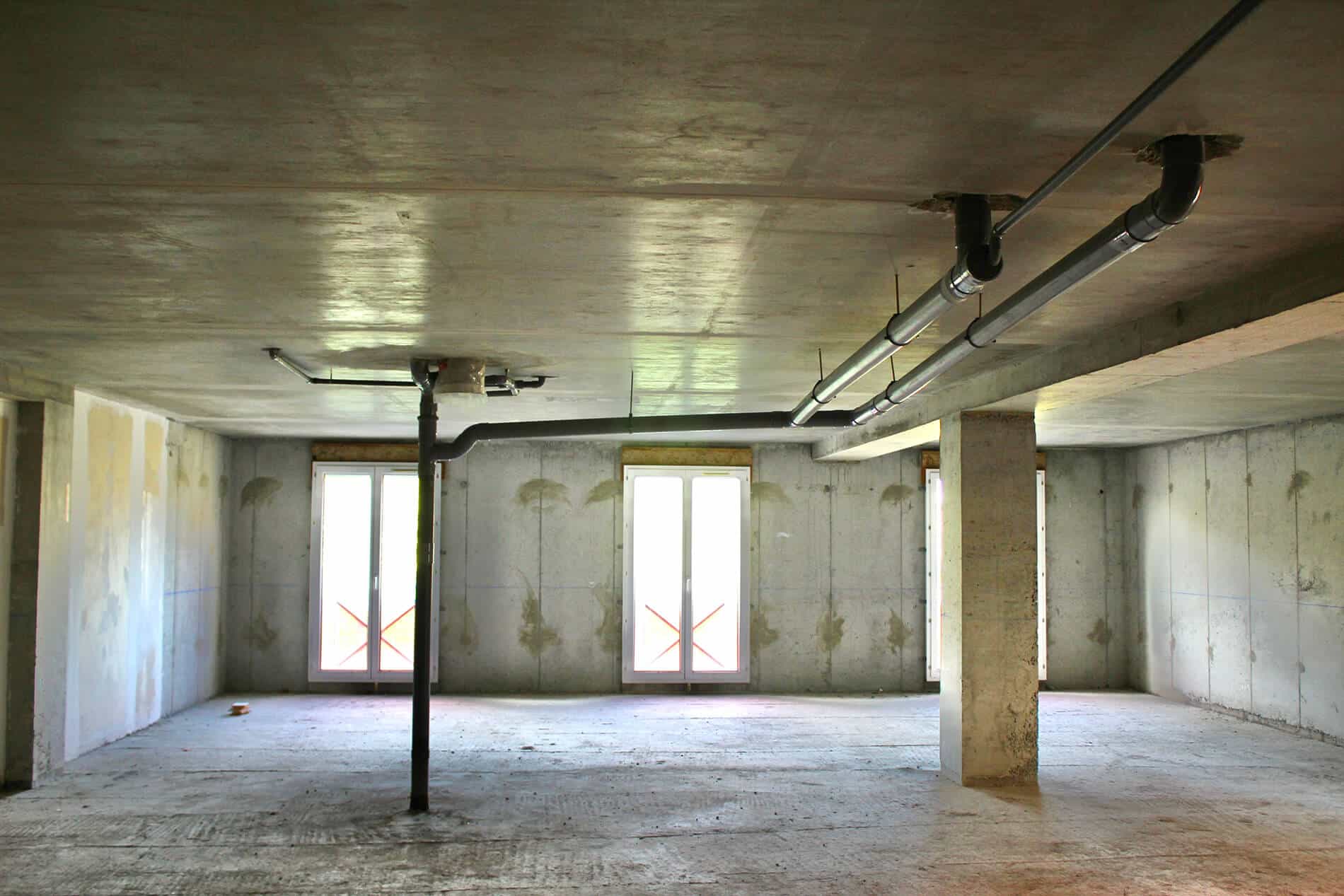 Wellness clinic a before image of an empty construction space with concrete floors and walls Wellness clinic a before image of an empty construction space with concrete floors and walls