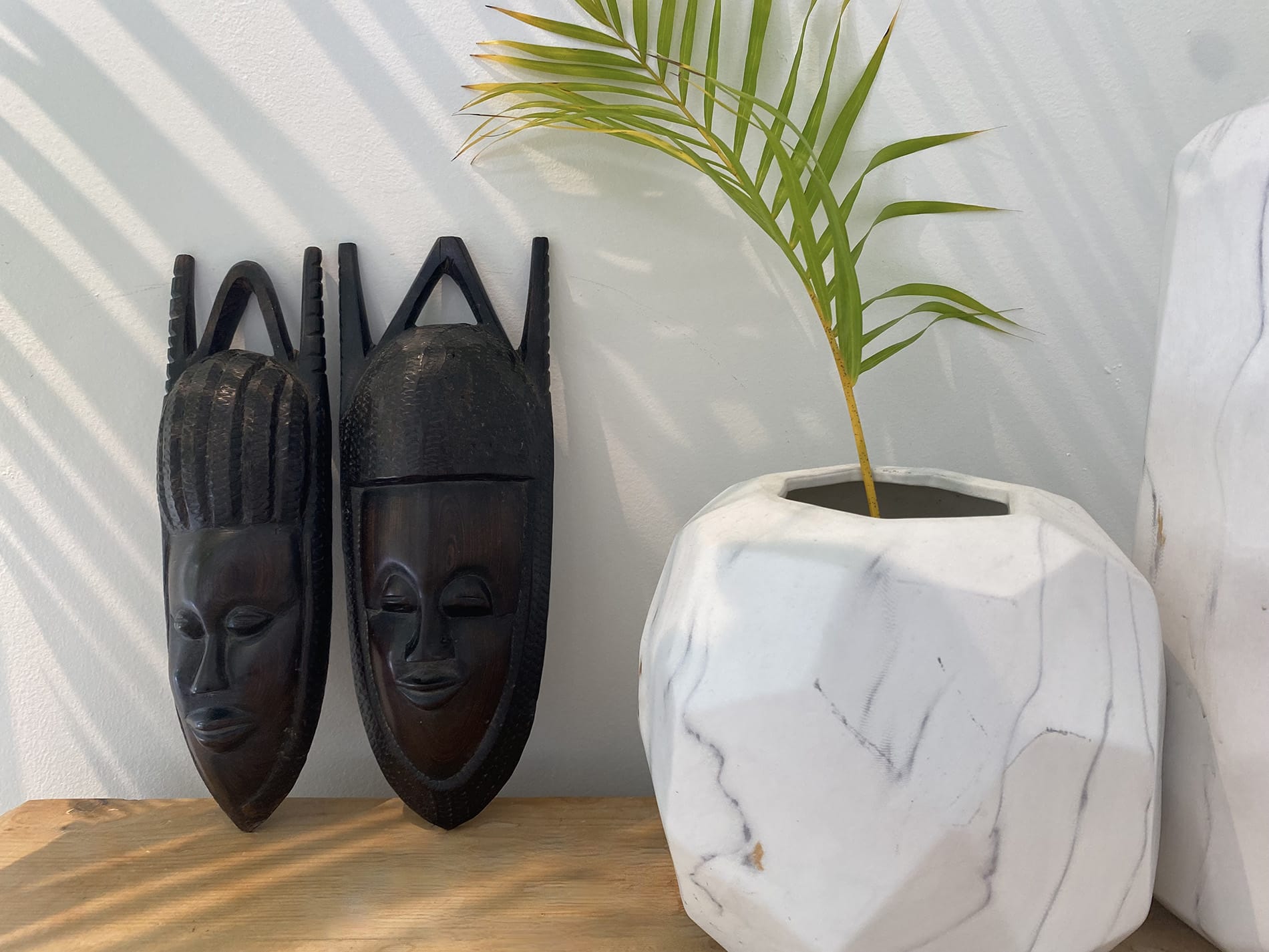 Coconut Grove home renovation - corner table decorated with two wooden faces, designed by Beatrice Leupold Coconut Grove home renovation - corner table decorated with two wooden faces, designed by Beatrice Leupold